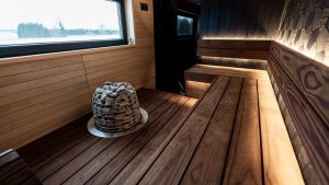 Experience a sleek Nordic sauna interior with modern wood design and LED lighting.